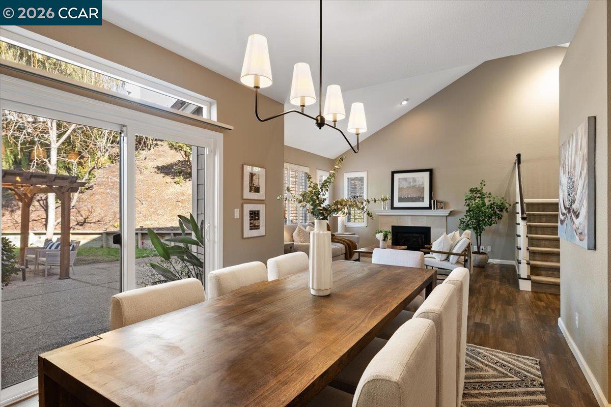 a view of a dining room with furniture a chandelier and wooden floor