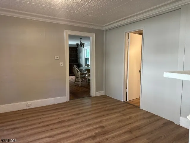 a view of a livingroom with wooden floor and closet
