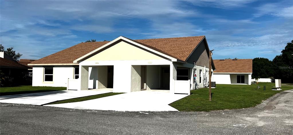 4153 Oak Loop Mulberry, FL 33860 - Photo 1 of 11 a front view of a house with a yard