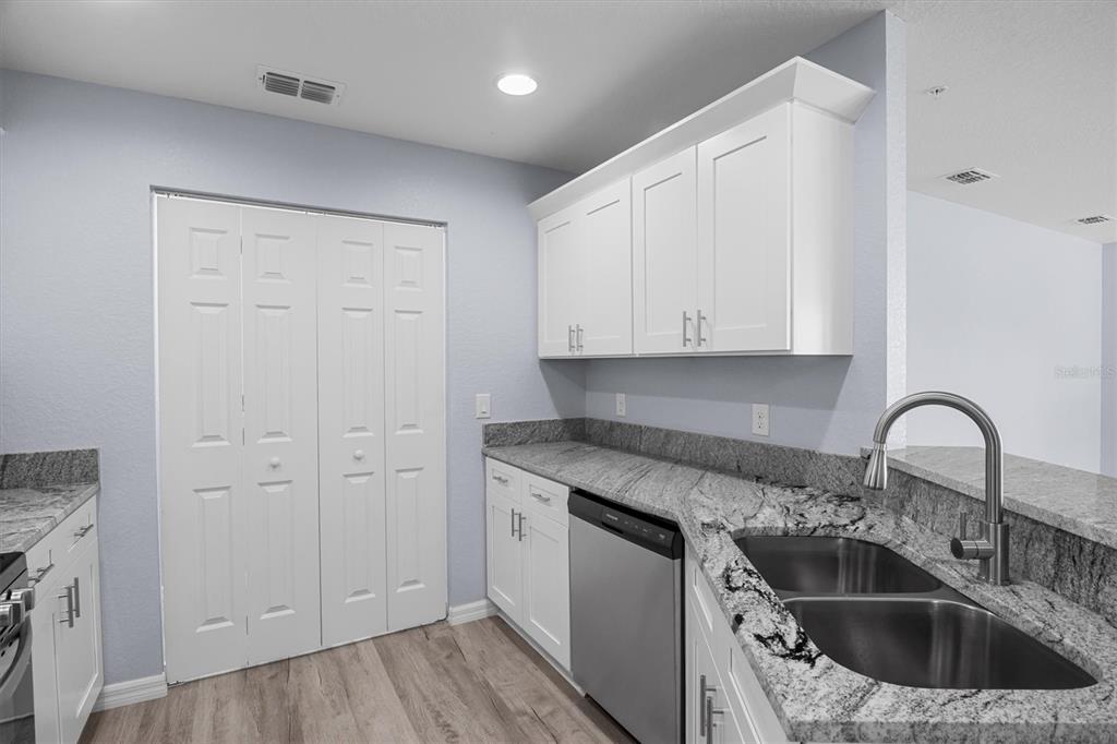4153 Oak Loop Mulberry, FL 33860 - Photo 6 of 11 a kitchen with white cabinets sink and dishwasher