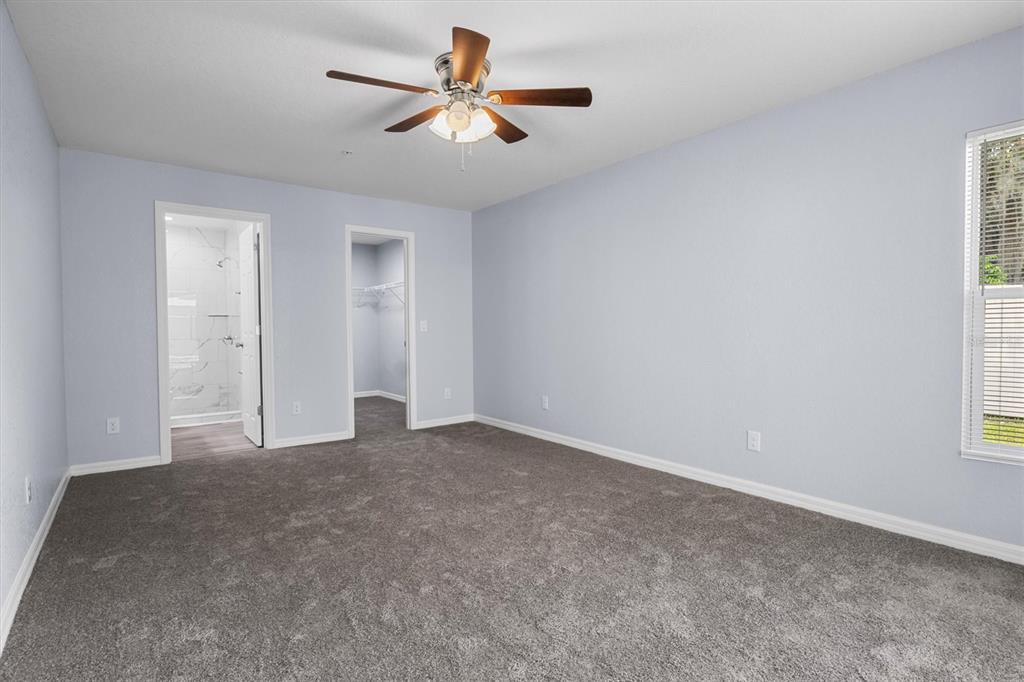 4153 Oak Loop Mulberry, FL 33860 - Photo 10 of 11 an empty room with a ceiling fan and window