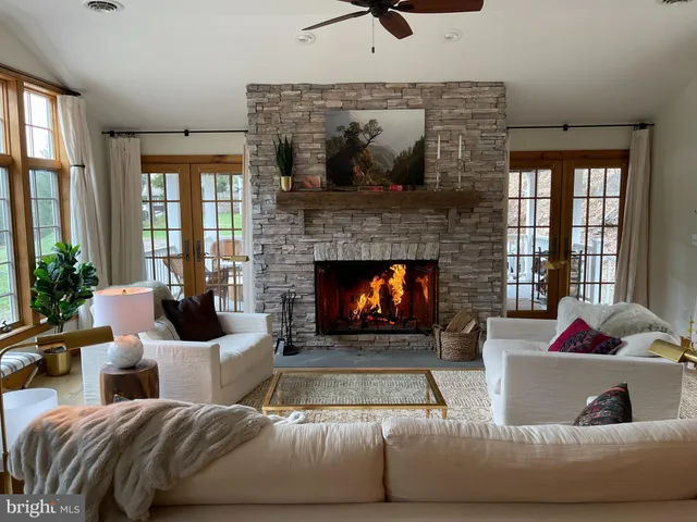 a living room with furniture fireplace and a flat screen tv