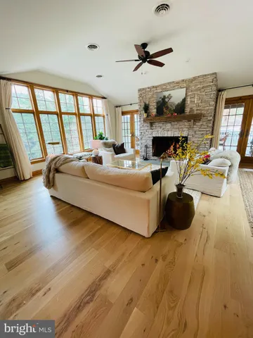 a living room with furniture and a fireplace