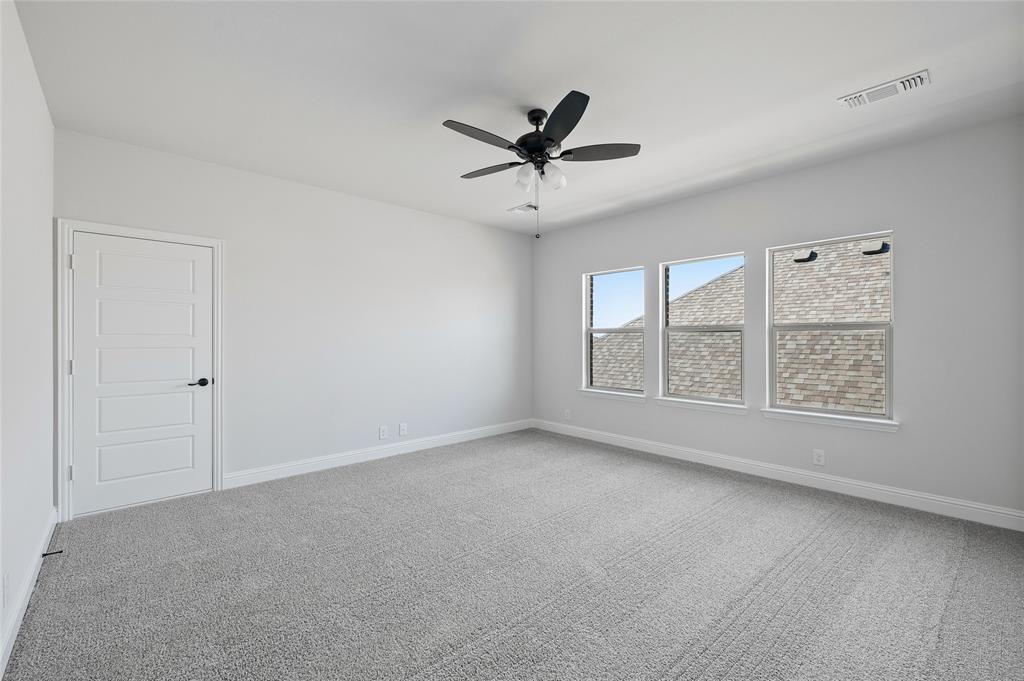 613 Brazos Drive Van Alstyne, TX 75495 - Photo 23 of 29 Spare room featuring light carpet and a ceiling fan