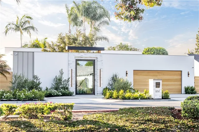 a front view of a house with a garden
