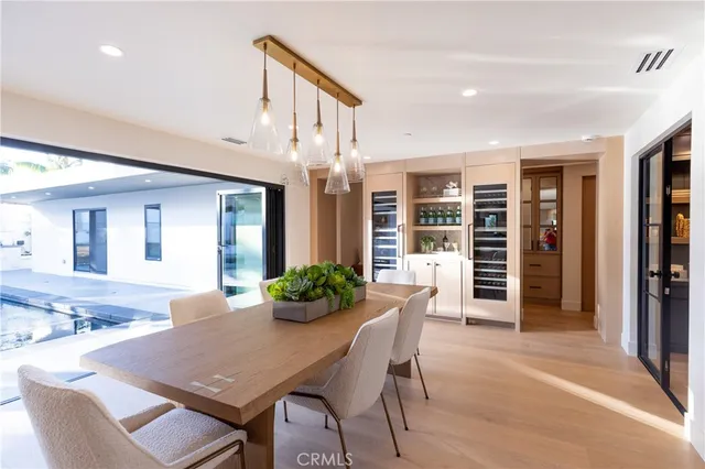 a dining room with furniture and a floor to ceiling window