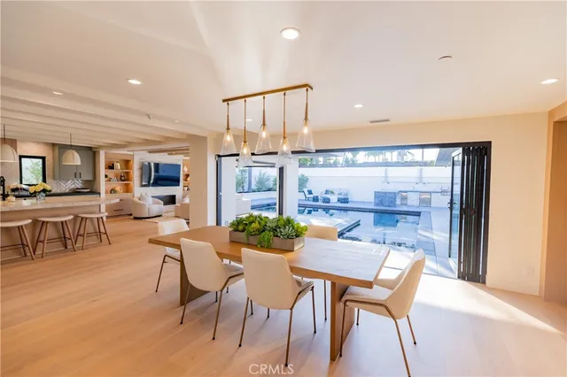 a living room with furniture a large window and wooden floor