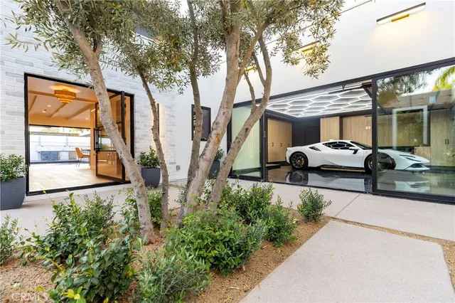a view of a patio with couches table and chairs and potted plants