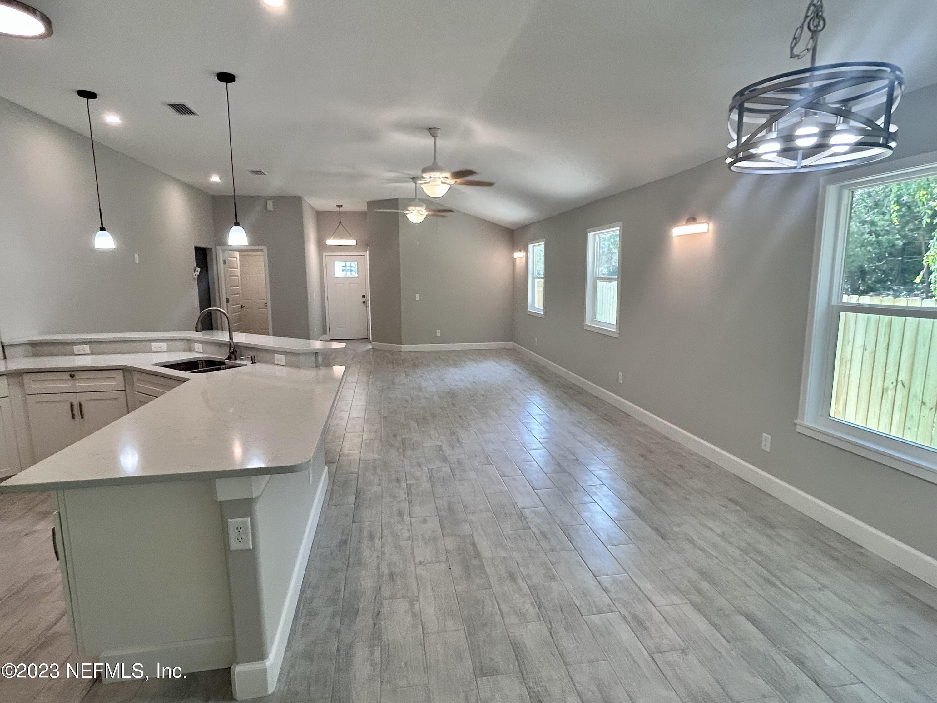 2585 A1A South St. Augustine, FL 32080 - Photo 17 of 37 an open kitchen with a chandelier