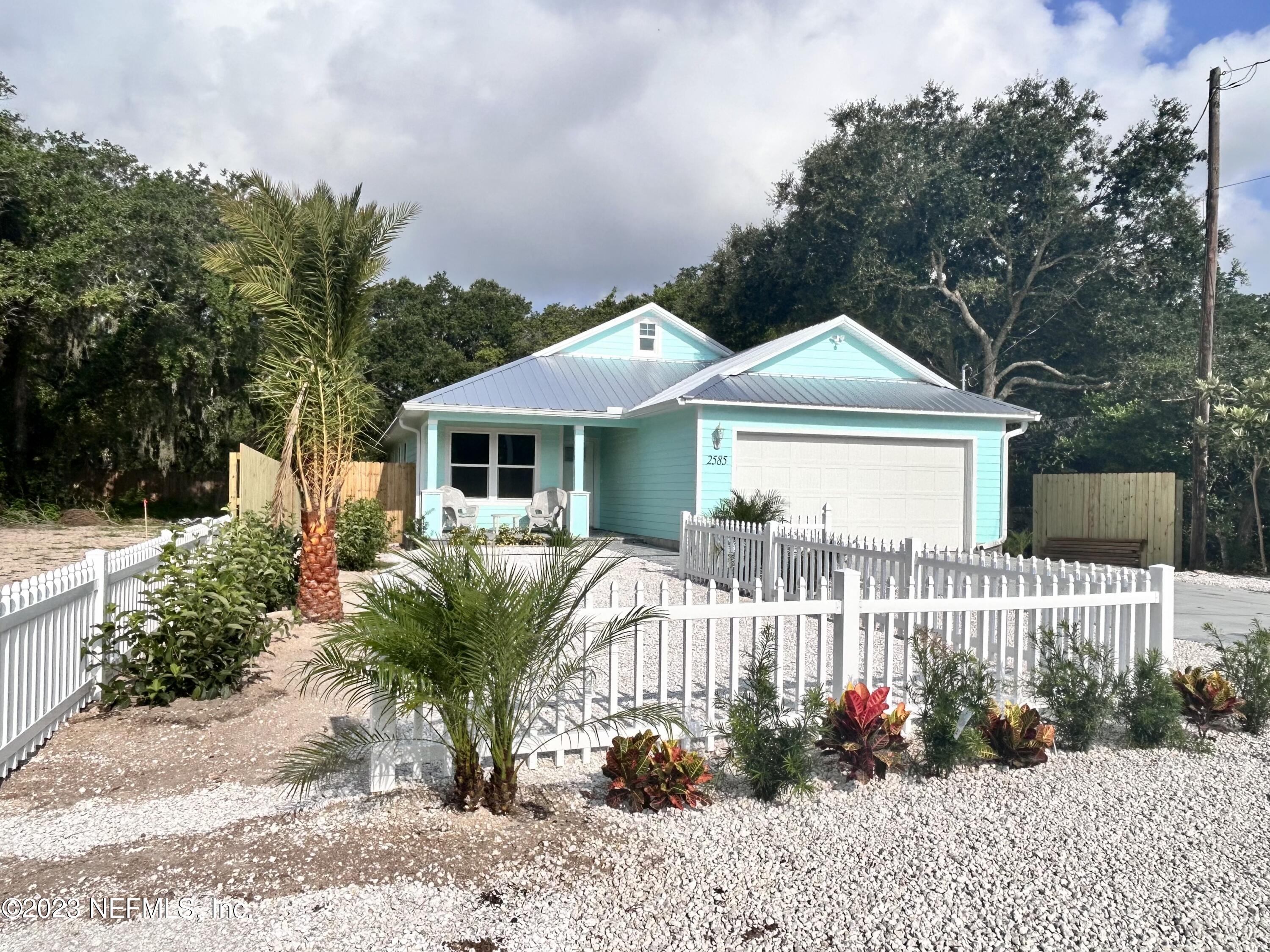 2585 A1A South St. Augustine, FL 32080 - Photo 2 of 37 a front view of a house with a garden