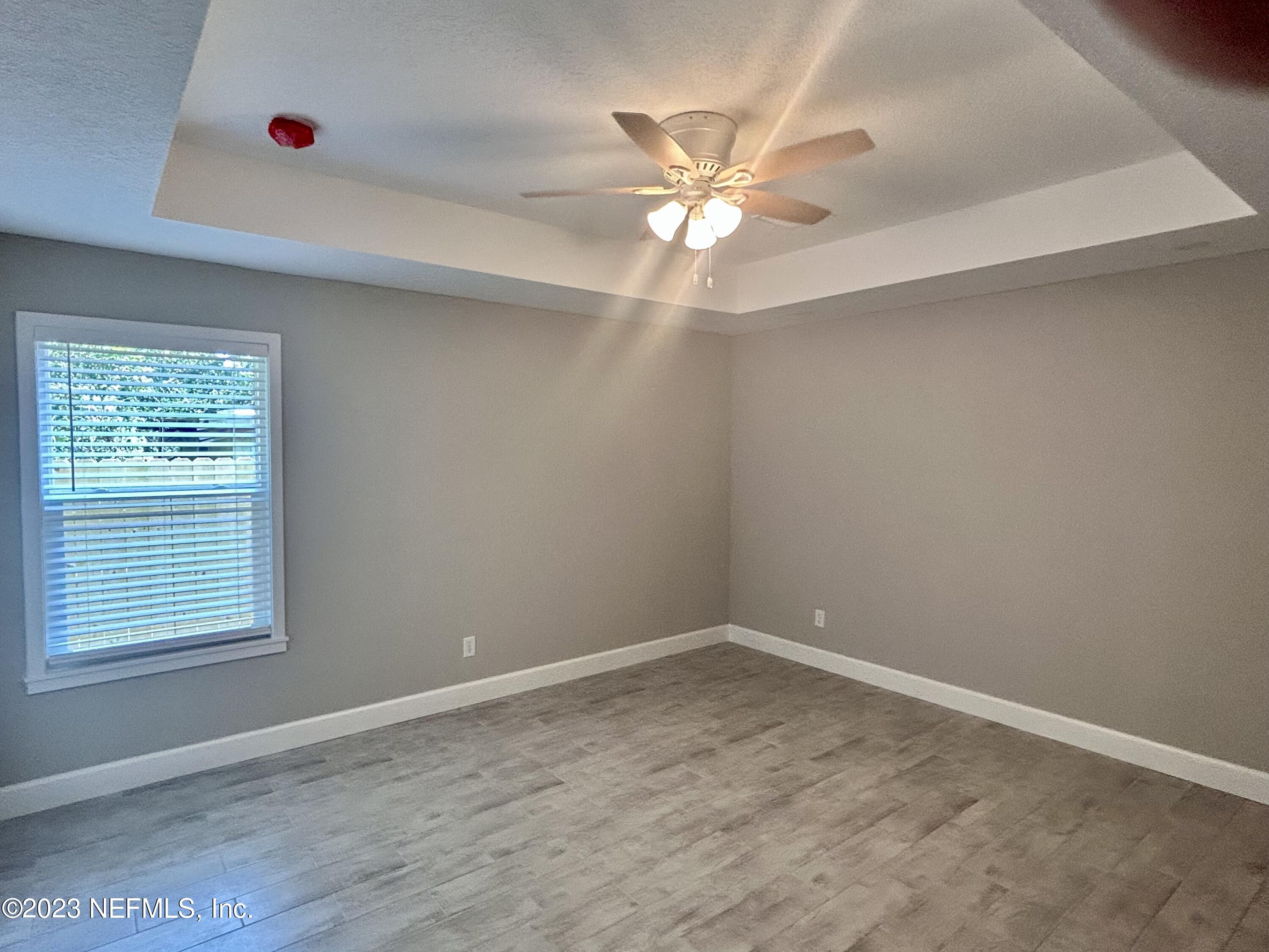 2585 A1A South St. Augustine, FL 32080 - Photo 22 of 37 an empty room with windows and fan