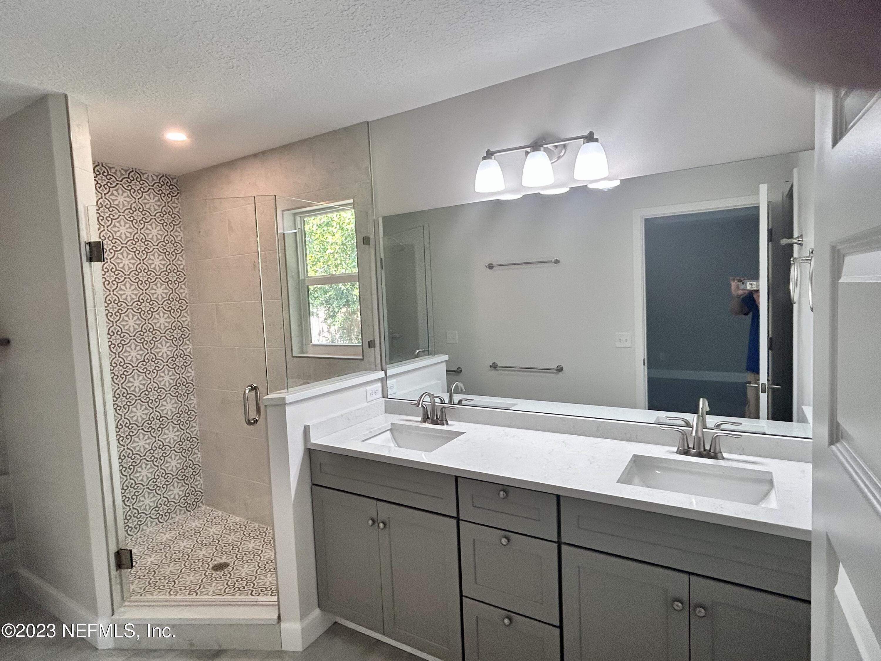 2585 A1A South St. Augustine, FL 32080 - Photo 24 of 37 a bathroom with a double vanity sink mirror and shower