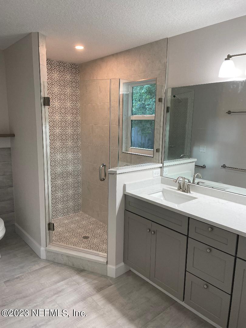 2585 A1A South St. Augustine, FL 32080 - Photo 25 of 37 a bathroom with a shower sink and mirror
