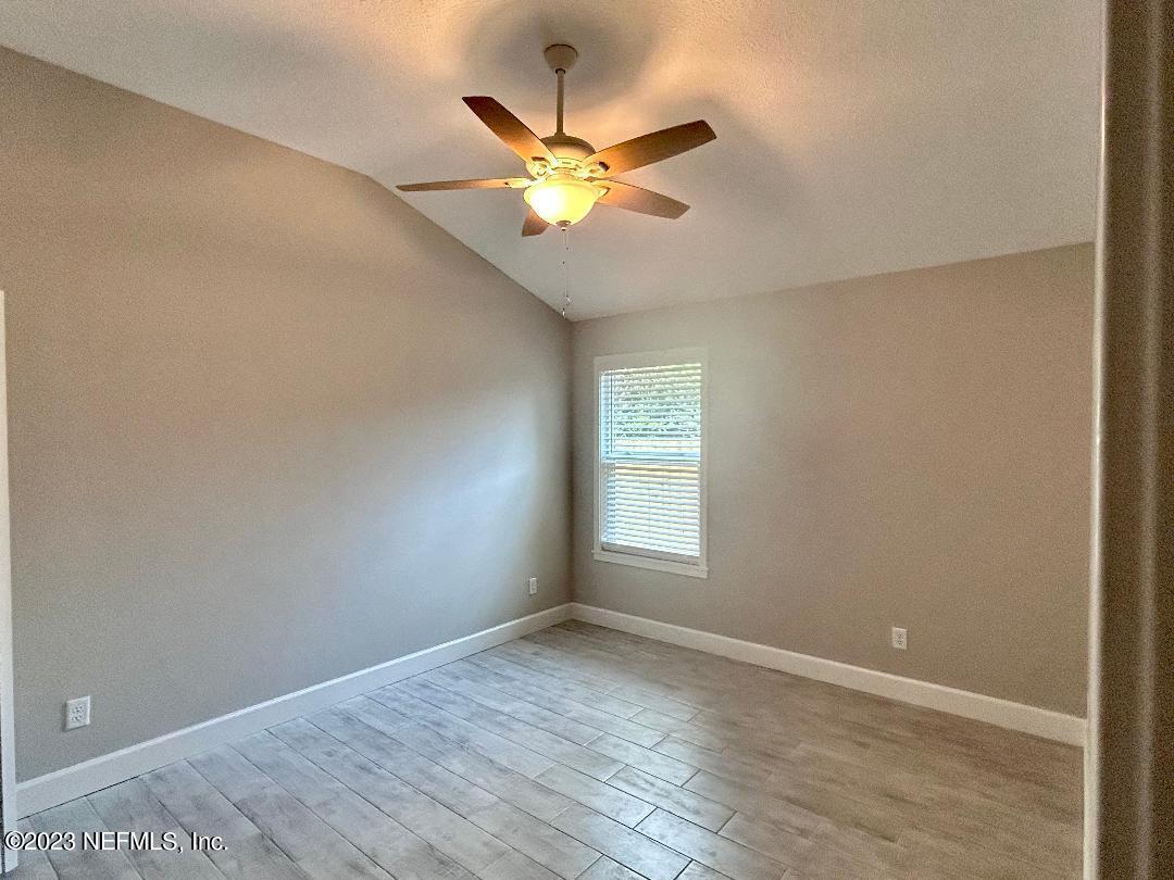 2585 A1A South St. Augustine, FL 32080 - Photo 27 of 37 wooden floor in an empty room with a window