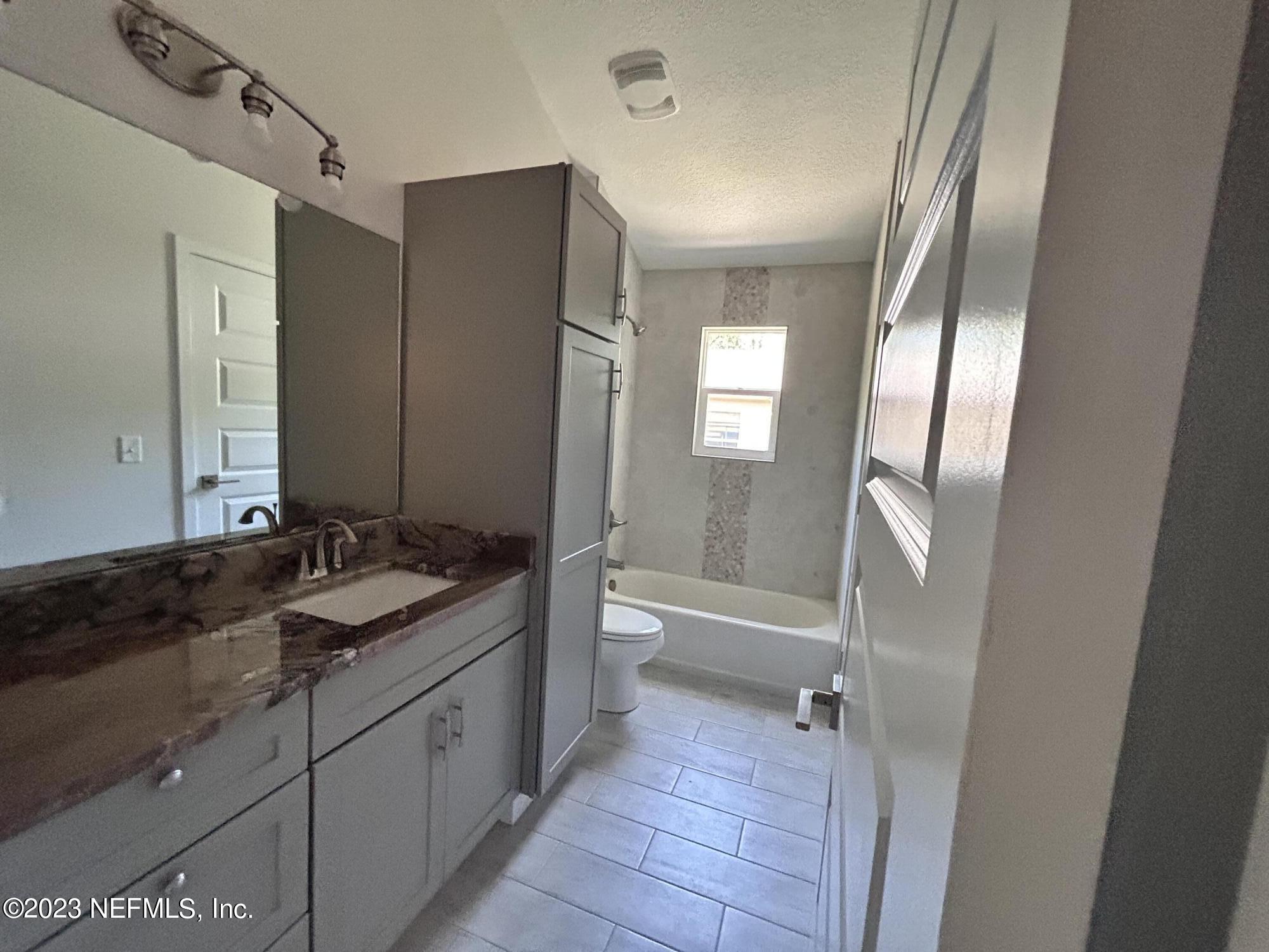2585 A1A South St. Augustine, FL 32080 - Photo 28 of 37 a bathroom with a double vanity sink toilet mirror and bathtub