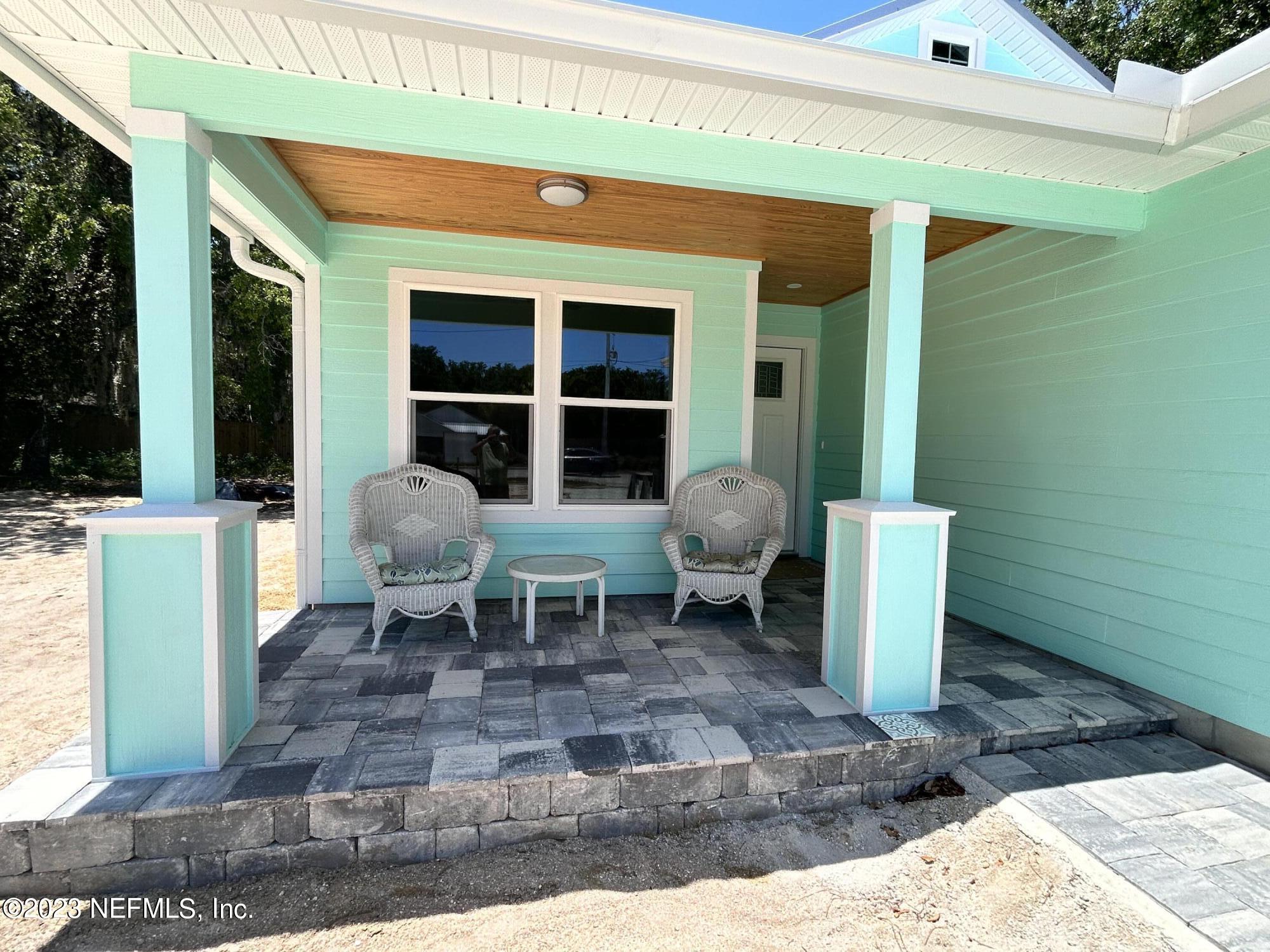 2585 A1A South St. Augustine, FL 32080 - Photo 5 of 37 a view of a patio with table and chairs near a yard