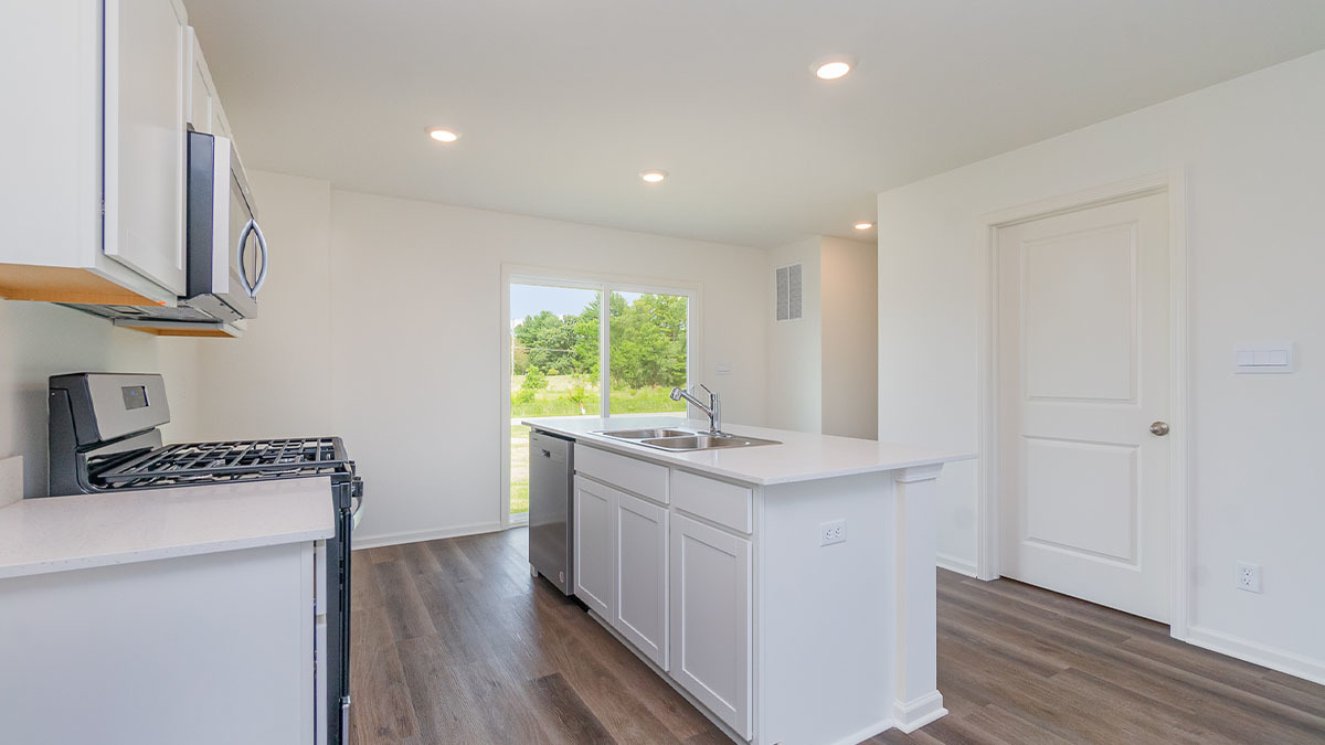 411 Conover Drive Joliet, IL 60421 - Photo 21 of 34 a kitchen with a stove a sink and a refrigerator
