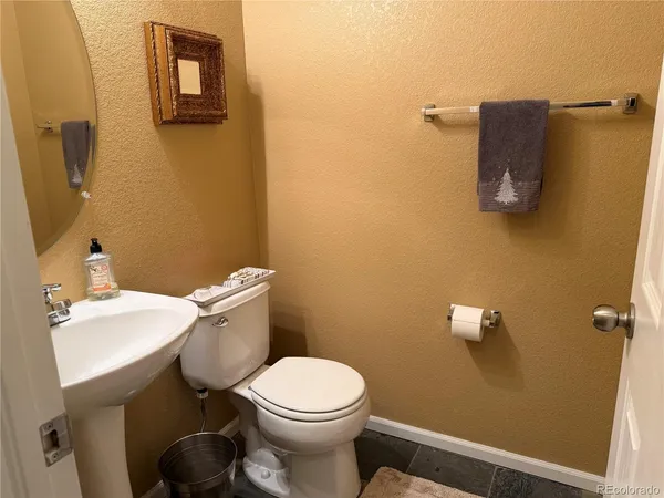 a white toilet sitting next to a bathroom sink