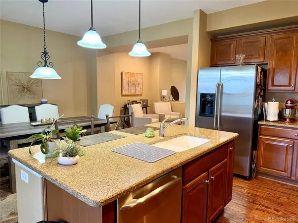 a kitchen with a table a sink and cabinets