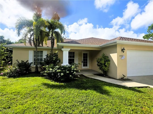 a view of a house with garden and yard