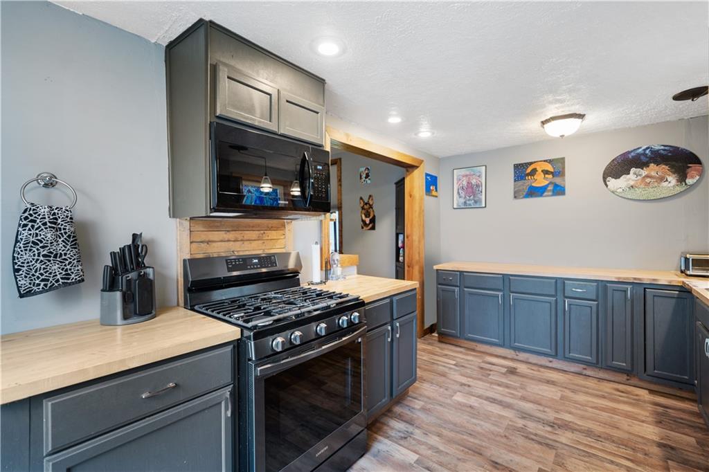 475 Irvin Avenue Rochester, PA 15074 - Photo 11 of 23 a kitchen with stainless steel appliances granite countertop a stove and a refrigerator