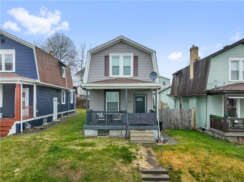 475 Irvin Avenue Rochester, PA 15074 - Photo 2 of 23 a front view of a house with a yard table and chairs