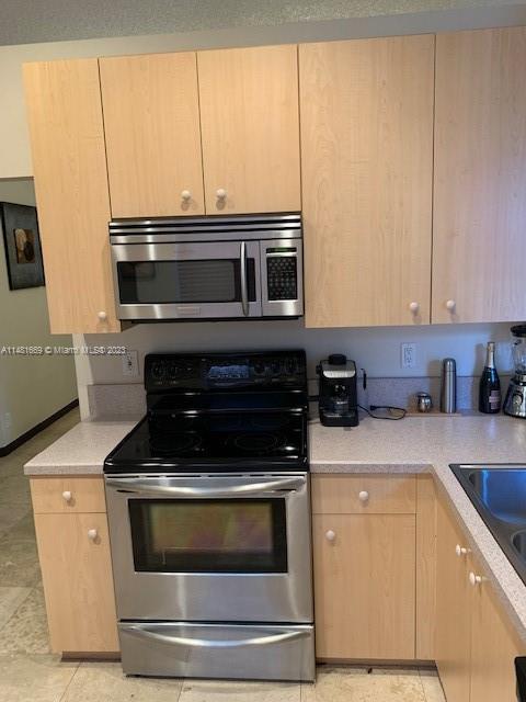 Savanna Weston, FL 33327 - Photo 6 of 9 a kitchen with a stove and white cabinets