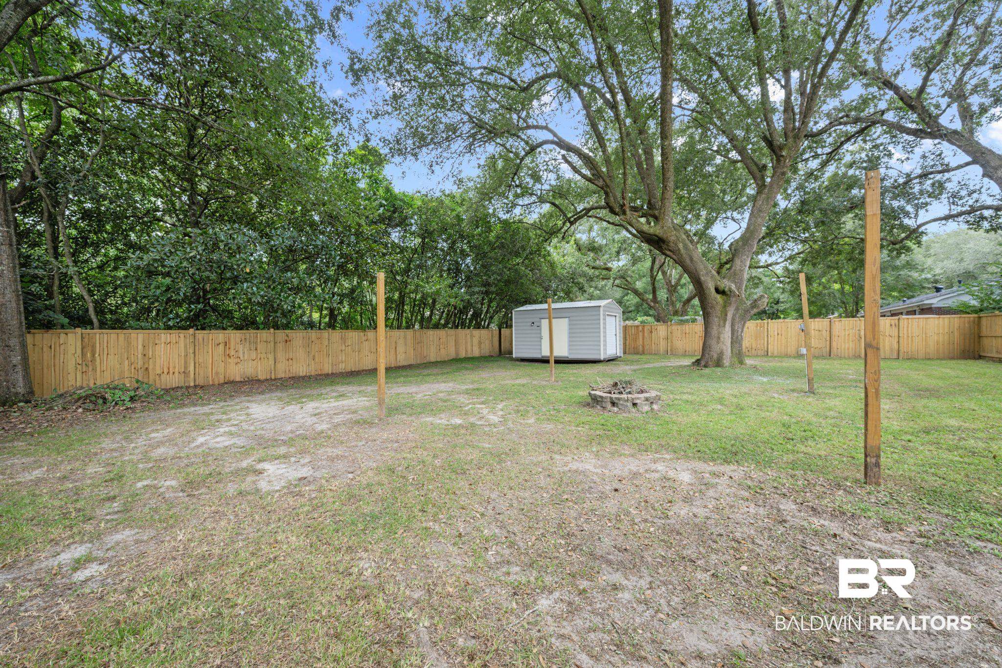 621 Ann Street Saraland, AL 36571 - Photo 16 of 21 View of yard featuring a storage shed