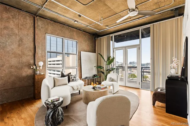 a living room with furniture and a floor to ceiling window