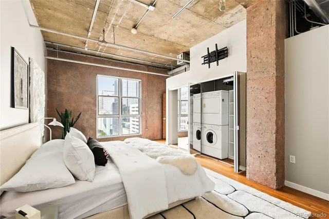 a spacious bedroom with a bed and a window