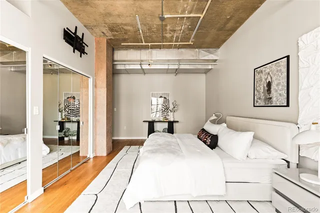 a bedroom with a bed and a mirror