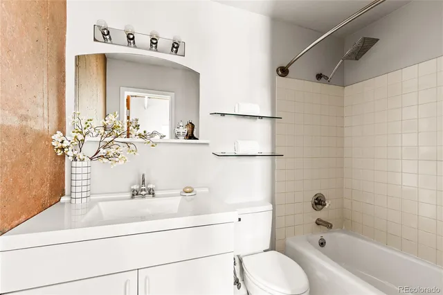 a bathroom with a sink mirror toilet and bathtub