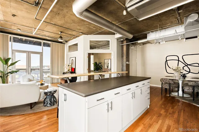a kitchen with stainless steel appliances granite countertop a sink stove and wooden floor