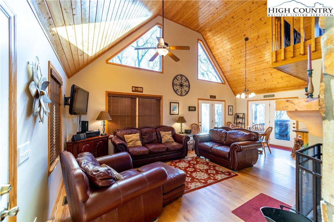 893 Deerwood Road Piney Creek, NC 28663 - Photo 12 of 50 a living room with furniture a clock and a large window