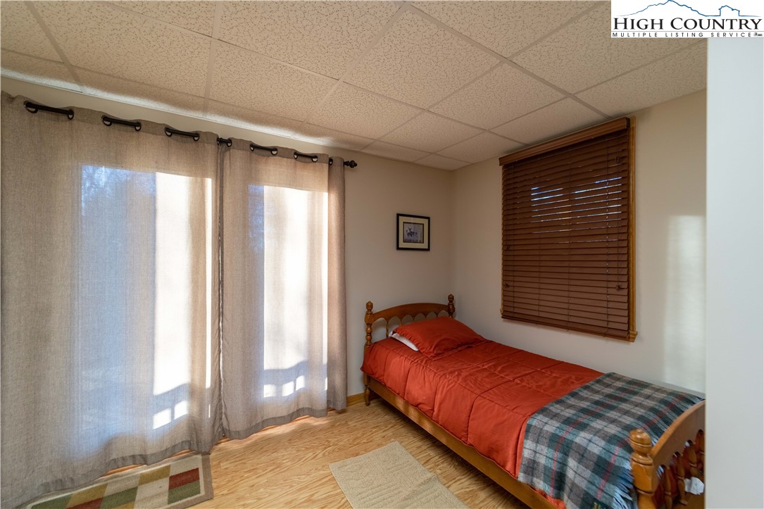 893 Deerwood Road Piney Creek, NC 28663 - Photo 33 of 50 a bedroom with a bed and window