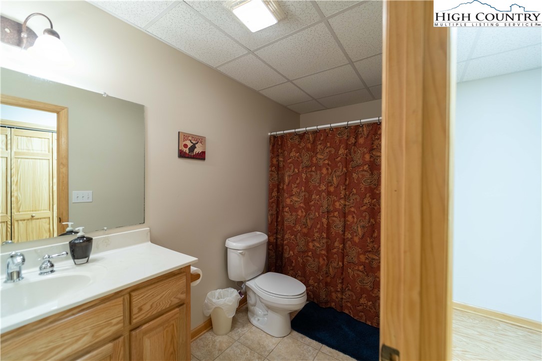 893 Deerwood Road Piney Creek, NC 28663 - Photo 36 of 50 a bathroom with a sink toilet and shower