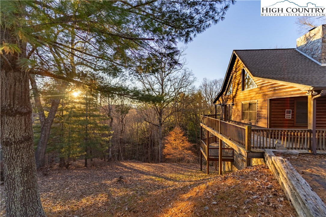 893 Deerwood Road Piney Creek, NC 28663 - Photo 38 of 50 a view of a house with a tree and wooden fence