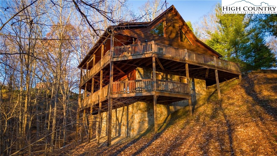 893 Deerwood Road Piney Creek, NC 28663 - Photo 44 of 50 a view of a house with a snow on the wall