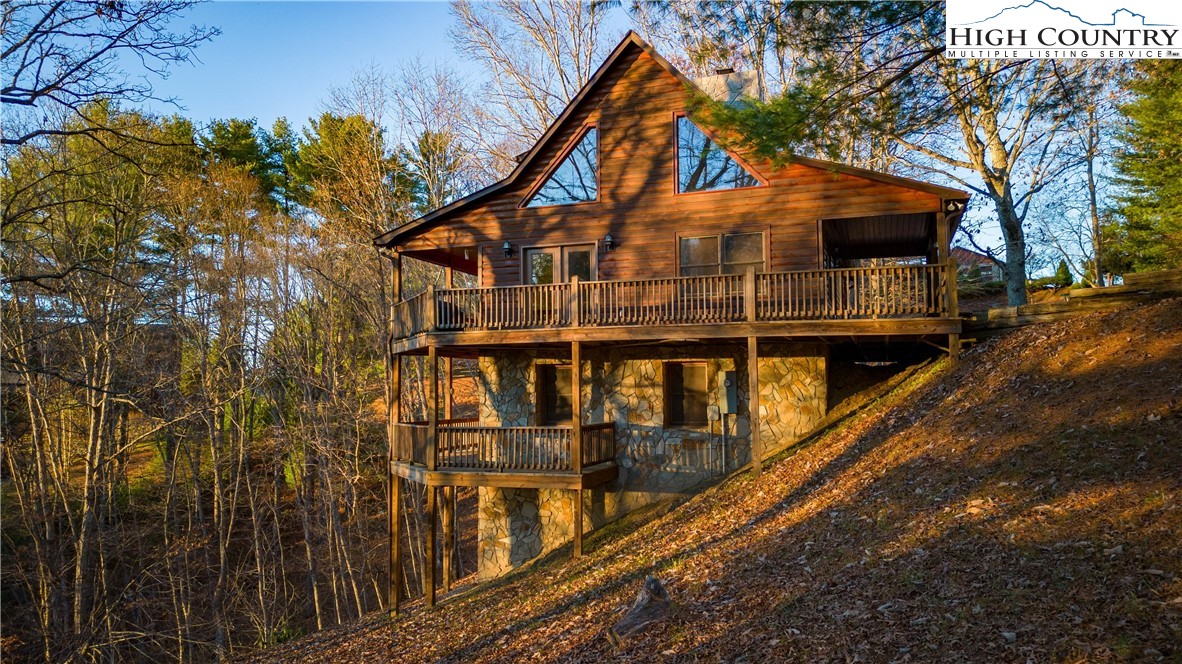 893 Deerwood Road Piney Creek, NC 28663 - Photo 47 of 50 a view of a house with a yard