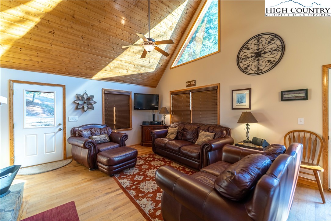893 Deerwood Road Piney Creek, NC 28663 - Photo 8 of 50 a living room with furniture a clock and a window