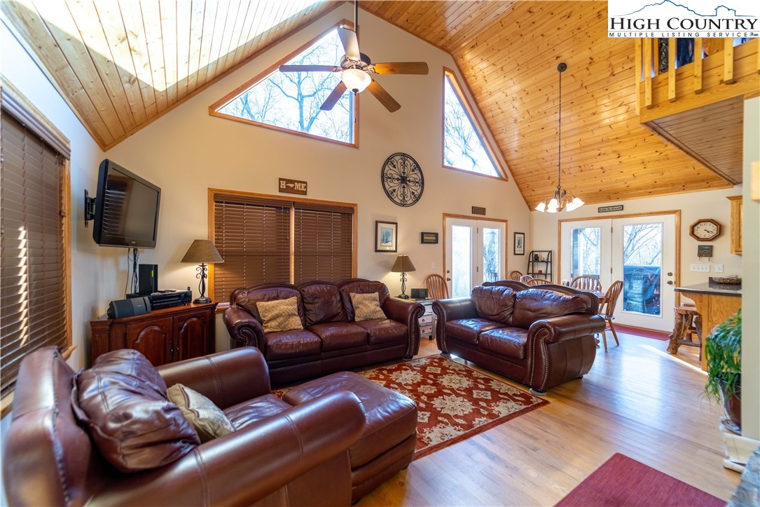 893 Deerwood Road Piney Creek, NC 28663 - Photo 9 of 50 a living room with furniture a large window and wooden floor