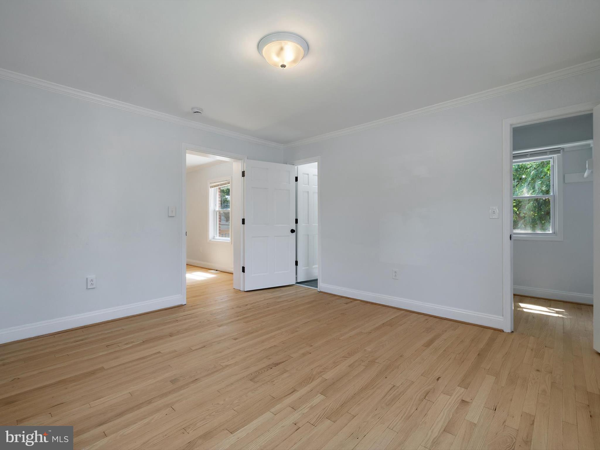 10109 Lorain Avenue Silver Spring, MD 20901 - Photo 18 of 48 an empty room with wooden floor and windows