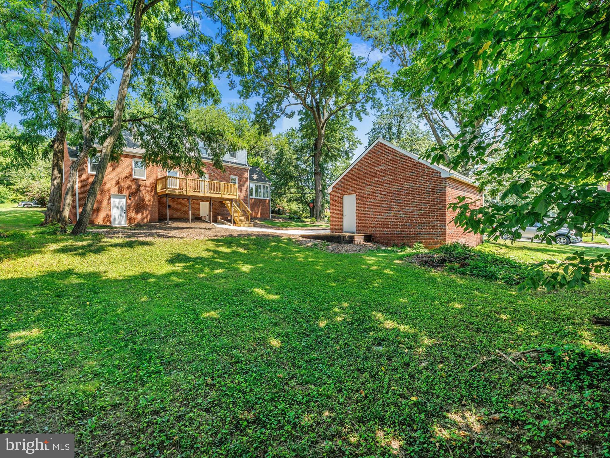 10109 Lorain Avenue Silver Spring, MD 20901 - Photo 36 of 48 a backyard of a house with table and chairs and a large tree