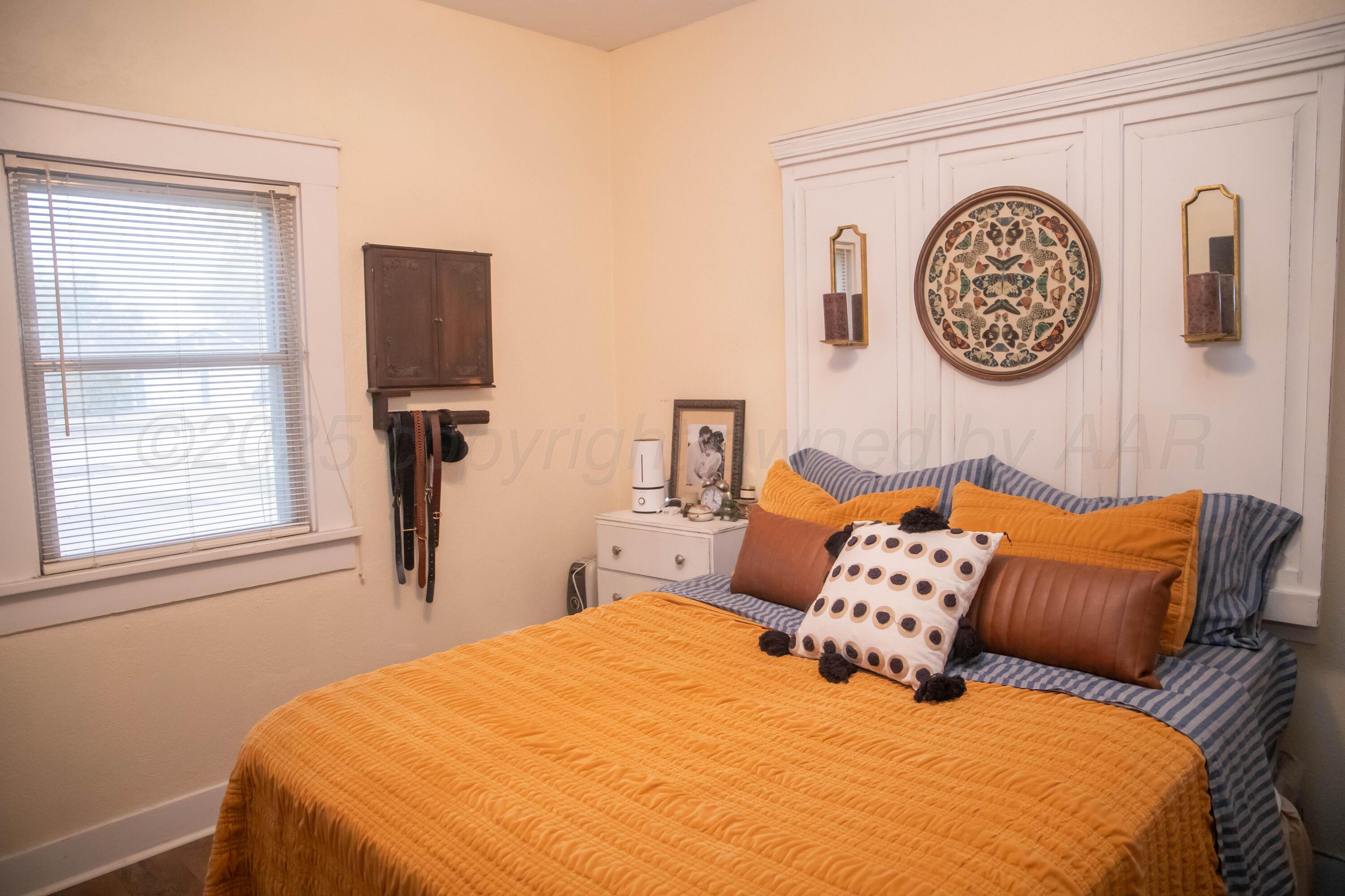300 East Broadway Street Panhandle, TX 79068 - Photo 11 of 23 a bedroom with a bed and a window
