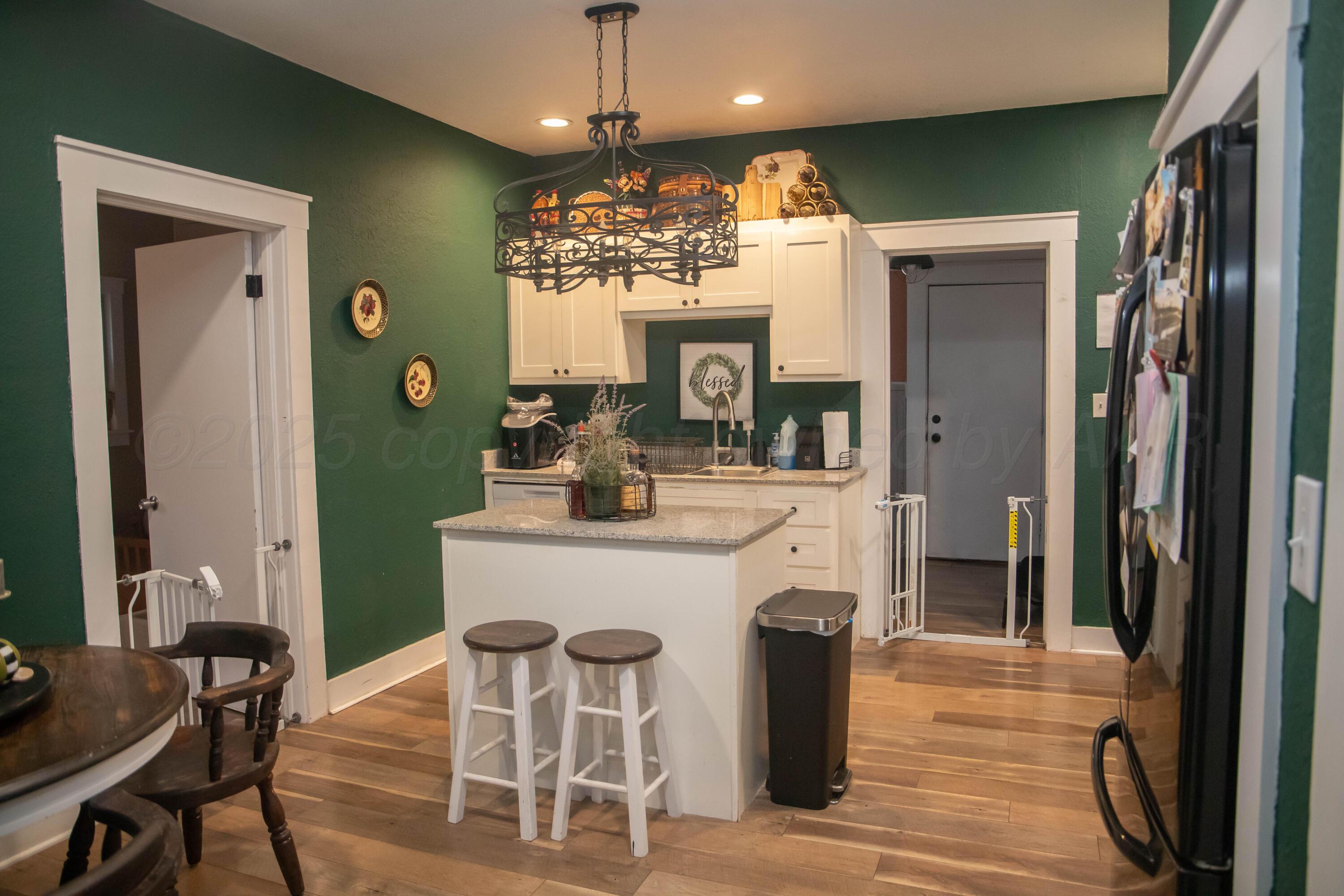 300 East Broadway Street Panhandle, TX 79068 - Photo 12 of 23 a view of a dining room with furniture and a chandelier