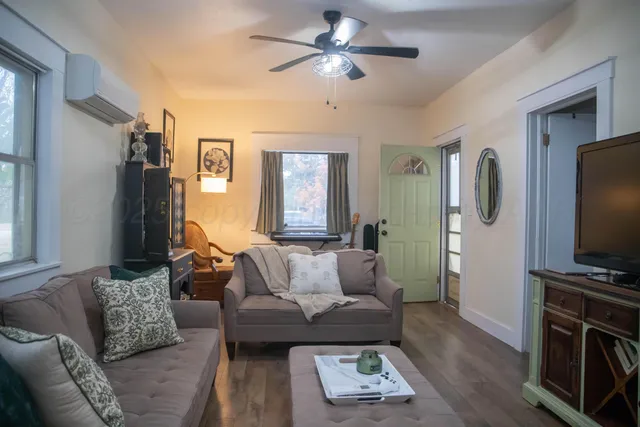 a living room with furniture and a flat screen tv