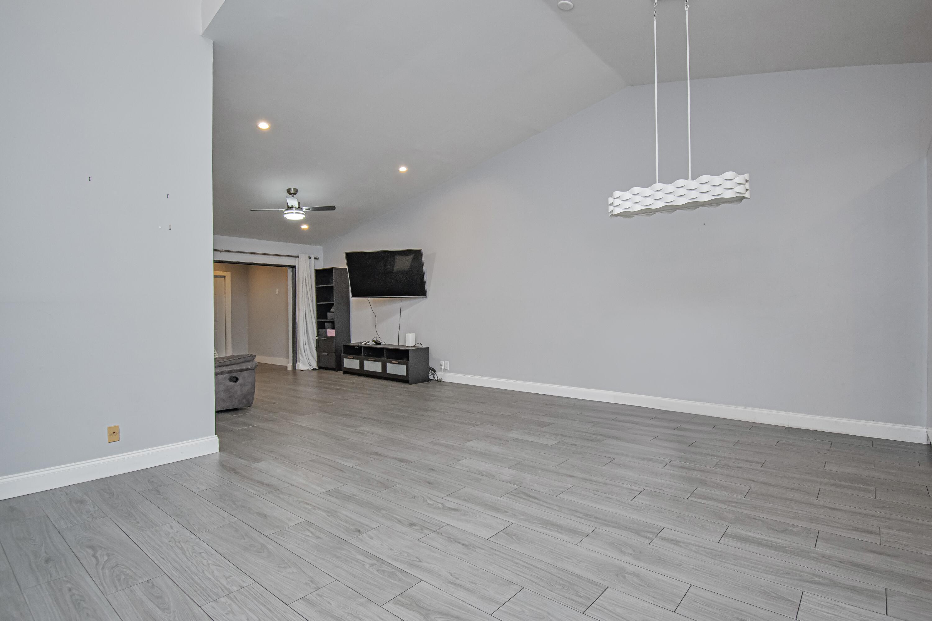 7706 Solimar Circle Boca Raton, FL 33433 - Photo 11 of 28 a view of a livingroom with a furniture wooden floor and a ceiling fan