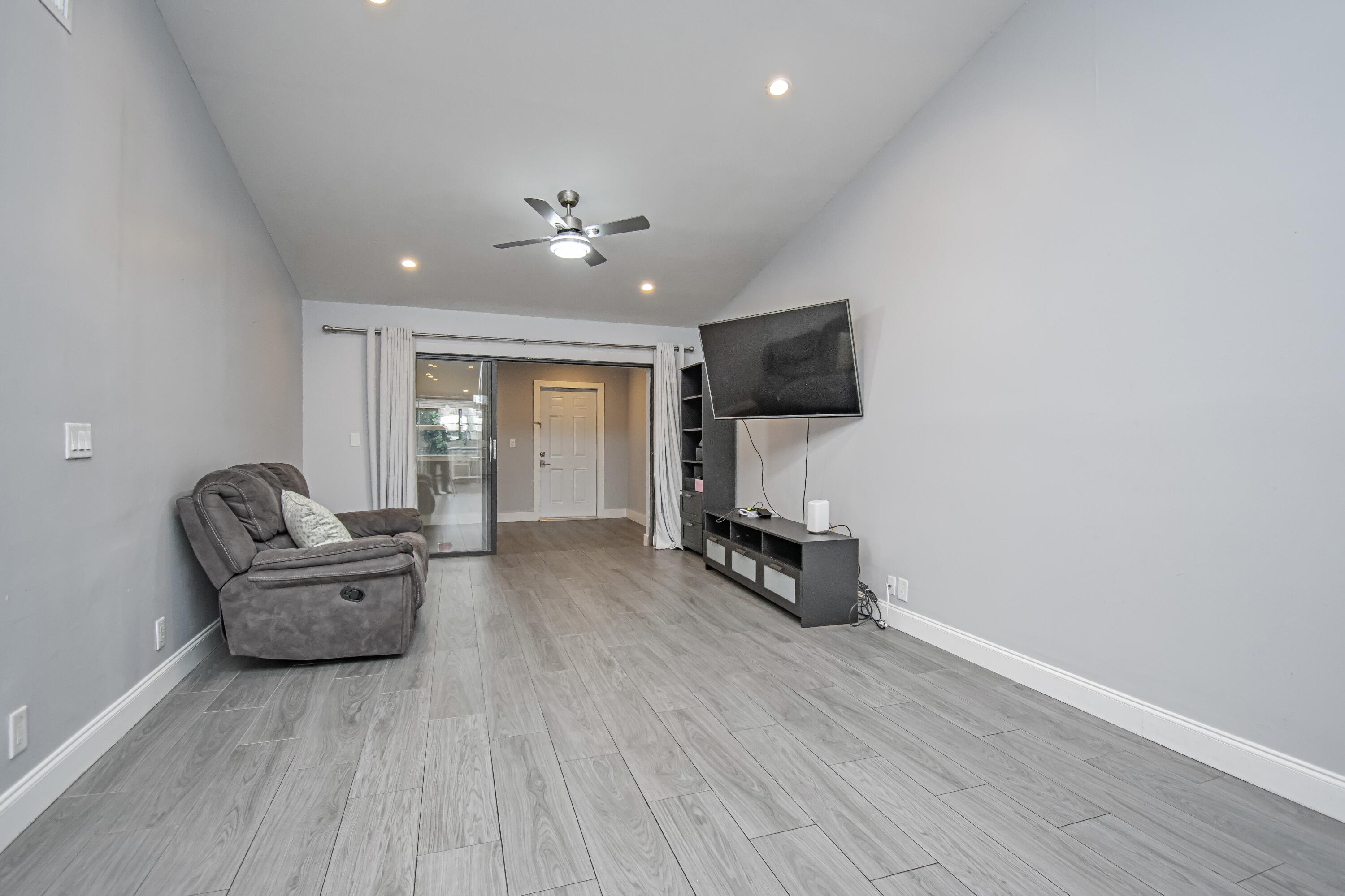 7706 Solimar Circle Boca Raton, FL 33433 - Photo 12 of 28 a living room with furniture and a flat screen tv