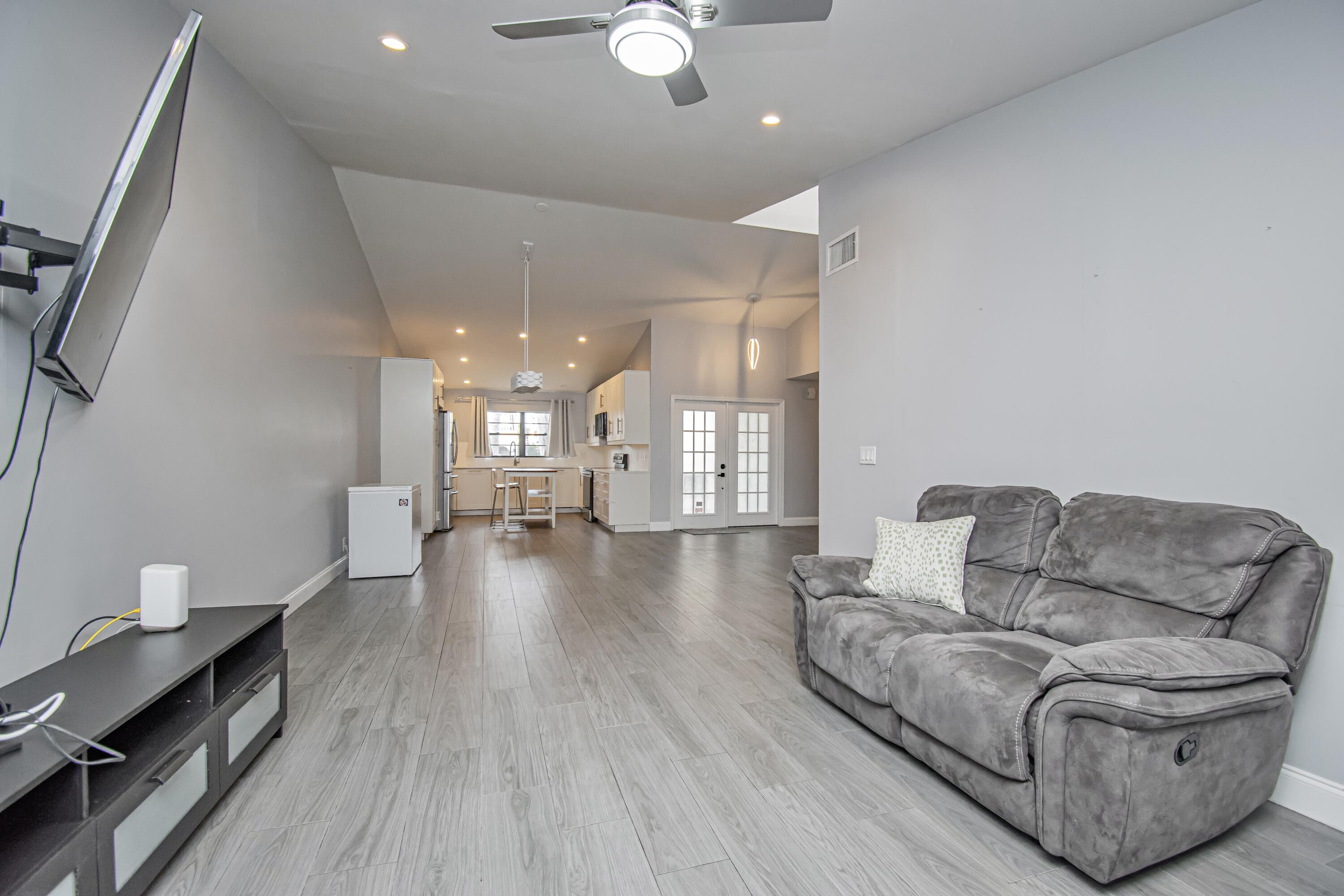 7706 Solimar Circle Boca Raton, FL 33433 - Photo 14 of 28 a living room with furniture and a chandelier