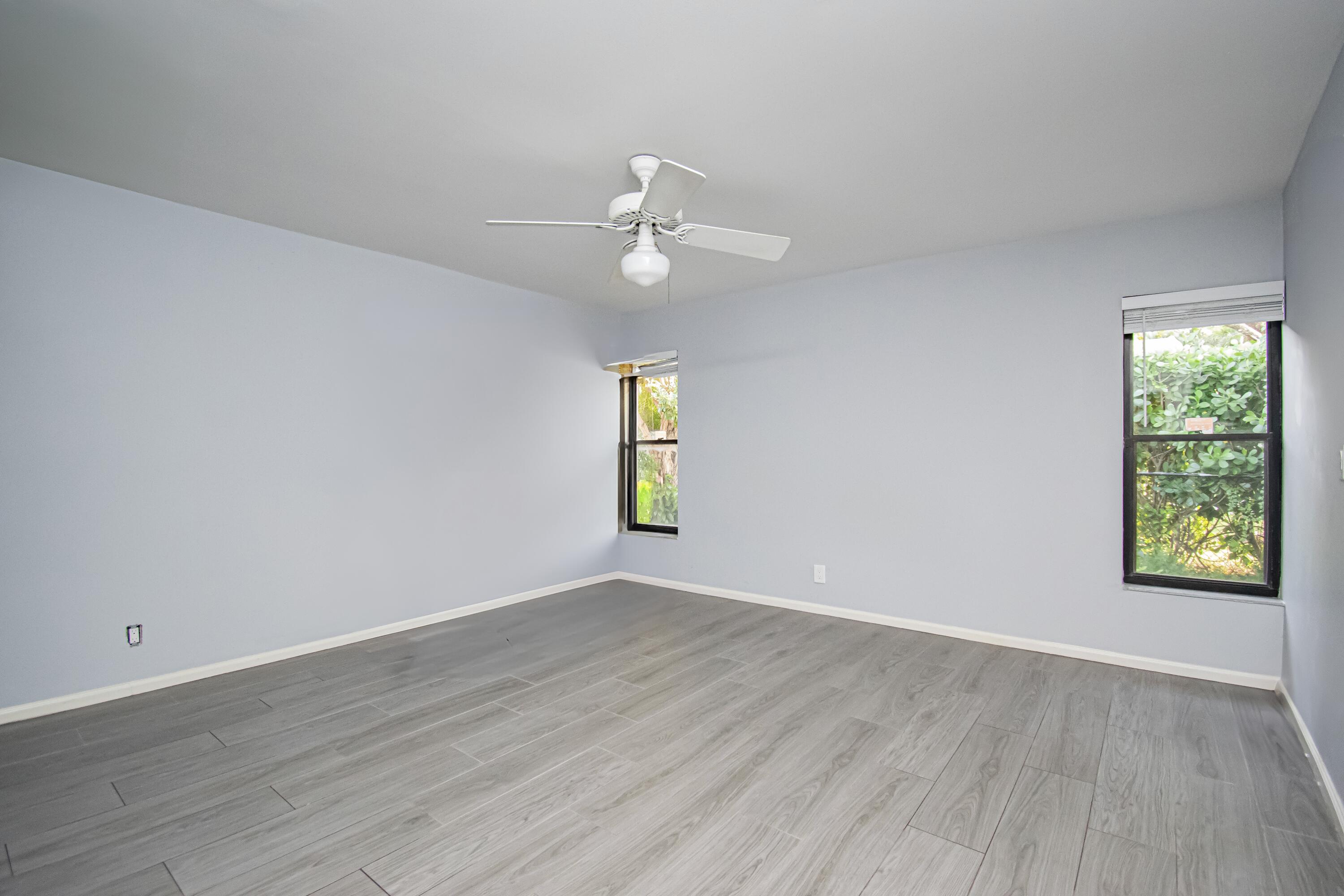 7706 Solimar Circle Boca Raton, FL 33433 - Photo 15 of 28 wooden floor in an empty room with a window